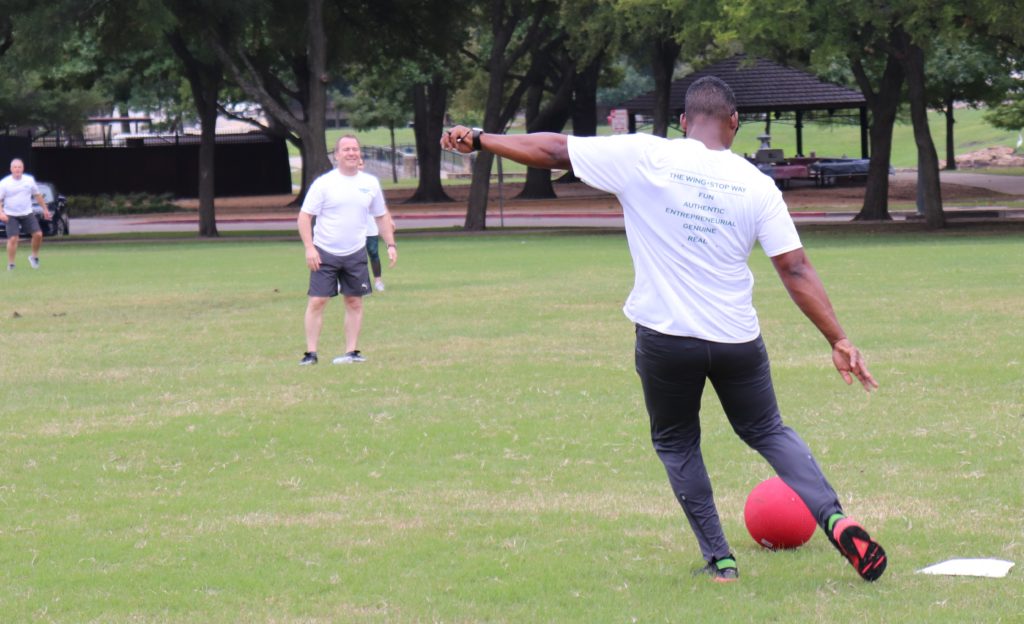 Donnie Upshaw playing kickball with the team.