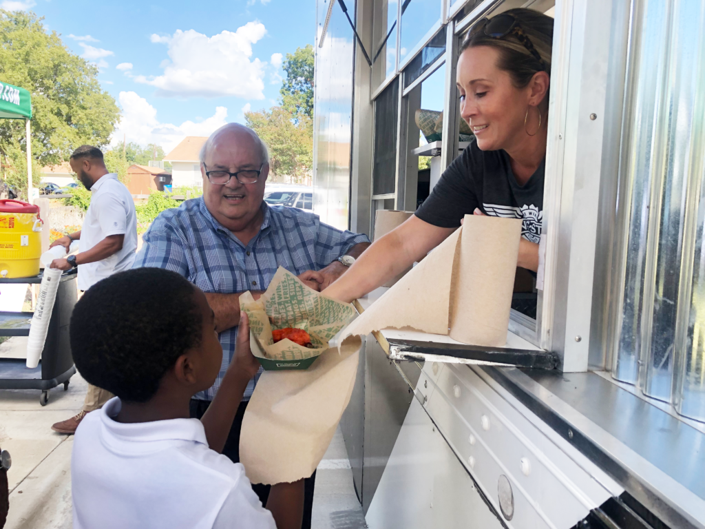 Wingstop Charities Serving HOPE Farm kids and families from the Wingstop Truck